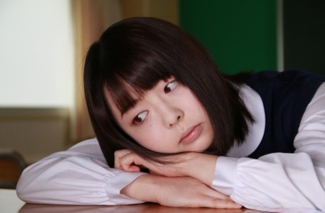 Adorable Japanese coed Tomoyo Isumi gets naked in socks aboard her desk