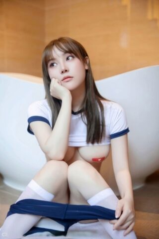 Brunette Asian teen flaunts her booty and breasts on the toilet