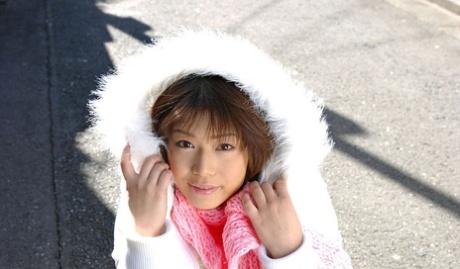61727821_001_8595 Japanese MILF Mai Haruna undoes her winter coat while wearing a bra and thong