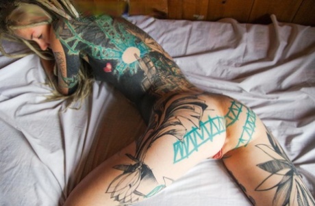 54824228_006_9f69 Heavily tattooed girl licks a penis while modelling in the nude