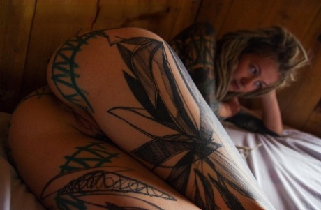 54824228_014_8750 Heavily tattooed girl licks a penis while modelling in the nude