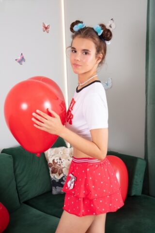 71766229_002_dfa7 Adorable teen Midia holds a couple of balloons before getting naked